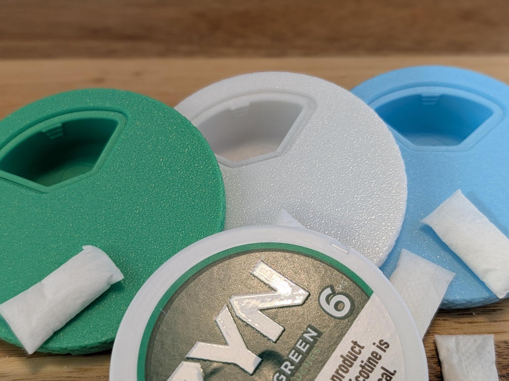 Close-up of the rotating access window on green, white and blue lids