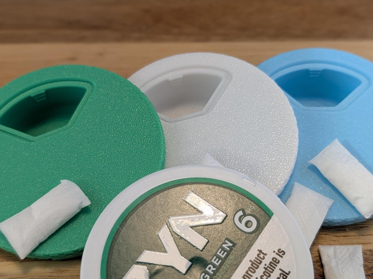 Close-up of the rotating access window on green, white and blue lids