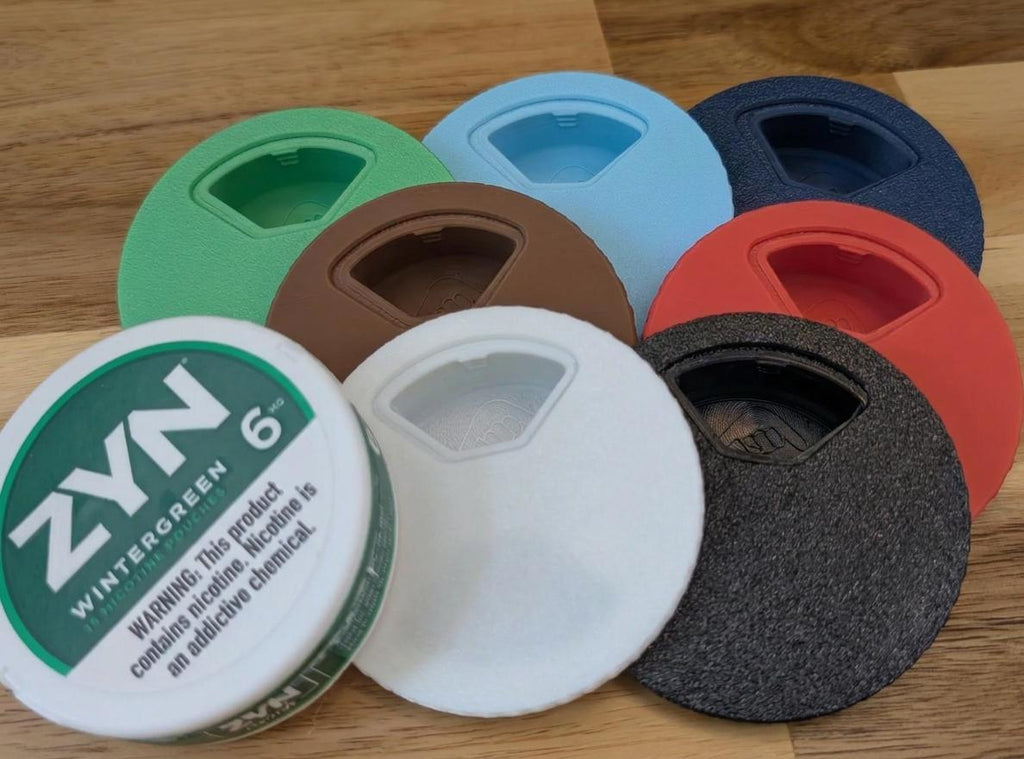 Twist-top can lids in seven colors next to a nicotine pouch can